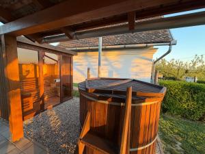 a wooden pergola with a hot tub in a yard at Horizont Haus in Tevel