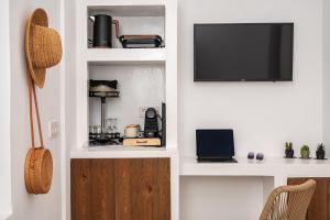 a living room with a tv on a white wall at Kalami in Kokkari