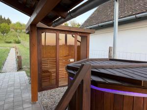 a wooden deck with glass doors on a house at Horizont Haus in Tevel