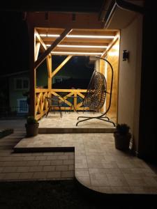 a chair sitting on a patio at night at Kuća za odmor "Moja idila" in Vrnjačka Banja