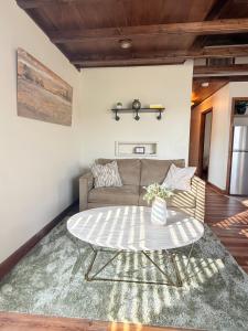 a living room with a couch and a table at Sunlit Loft, Near GSP and Private Entry in Greer
