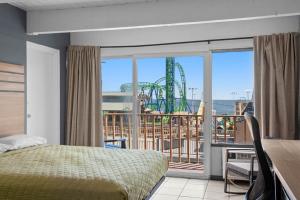 a bedroom with a view of a roller coaster at Aztec Ocean Resort in Seaside Heights +29 photos
