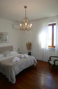 a bedroom with a bed and a chandelier at Villa Iliana in Lucca