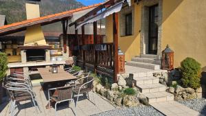 a patio with a table and chairs in front of a house at Skiprivat in Ružomberok