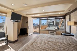 a bedroom with a large bed and a balcony at Aztec Ocean Resort in Seaside Heights