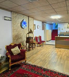 a waiting room with chairs and a pool table at HERSH Palace Hotel in Erbil