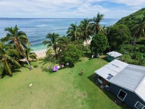 an overhead view of a house and the beach at Knox's Beachfront Homestay in Nalauwaki