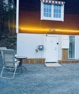 a table and chairs in front of a house at Sollidsvägen 1 F in Bro +10 photos