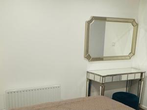 a mirror on a wall next to a bed at Sollidsvägen 1 F in Bro