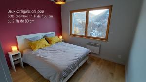 a small bedroom with a bed with a window at Gite La Cueille in Saint-Claude