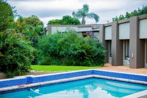 a swimming pool in front of a house at Noah Garden in Johannesburg
