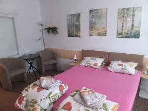 a bedroom with two beds and a table and two chairs at Soukromé ubytování 1 in Zlín