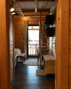 a living room with a couch and a window at Sohana Chalet I Design I Apartment and Guest Rooms I Sauna I AC in Kappel-Grafenhausen
