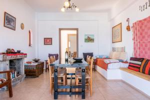 a living room with a table and a couch at Poppy Villas in Agios Nikolaos