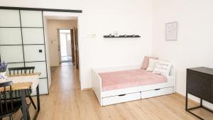 a bedroom with a bed and a dining room at City Center Apartment in Brno