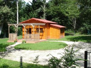 a small cabin with a porch in a yard at Chalet l'écureuil in Treigny