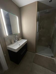 a bathroom with a sink and a shower at Anna and Jims Cottage in Claudy