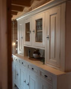 a kitchen with white cabinets and a sink at Sohana Chalet I Design I Apartment and Guest Rooms I Sauna I AC in Kappel-Grafenhausen +58 photos