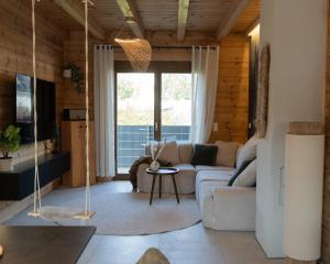 a living room with a couch and a swing at Sohana Chalet I Design I Apartment and Guest Rooms I Sauna I AC in Kappel-Grafenhausen
