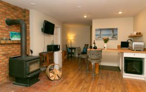 a living room with a fireplace and a stove at Similkameen Valley Resort in Cawston