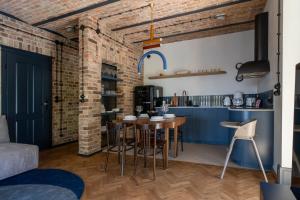 a kitchen and dining room with a brick wall at apartamenty64200 in Wolsztyn