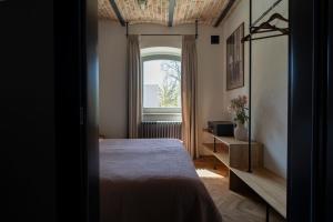 a bedroom with a bed and a window at apartamenty64200 in Wolsztyn