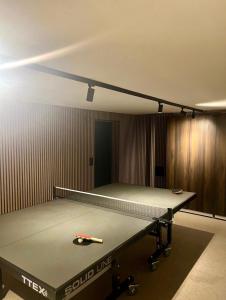a ping pong table in a room with a pool table at Spacious, comfortable villa close to lake in Sigtuna