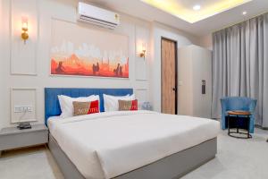 a bedroom with a large white bed in a room at Aceotel Select Virat, Vijay Nagar in Indore