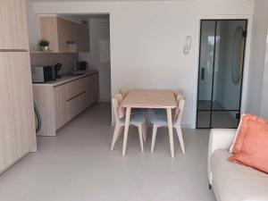 a small kitchen with a table and a couch at Studio met zeezicht op Heldenplein in Knokke-Heist +8 photos