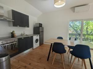 a kitchen with a table and chairs in a room at Two-bedroom apartment with air conditioning in Vichy +1 photo
