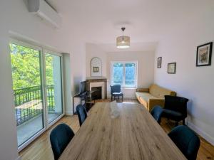 a living room with a large wooden table and chairs at Two-bedroom apartment with air conditioning in Vichy