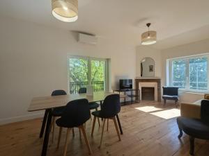 a living room with a dining room table and chairs at Two-bedroom apartment with air conditioning in Vichy