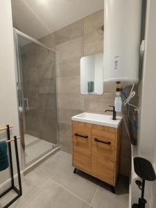 a bathroom with a sink and a shower at Two-bedroom apartment with air conditioning in Vichy