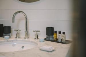 a bathroom sink with cosmetics on a counter at Villa Tri Men in Combrit +59 photos