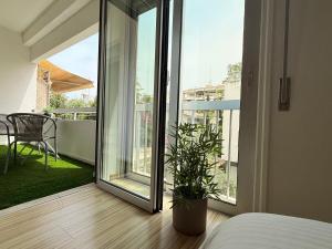 a bedroom with a bed and a sliding glass door at Nicosia Neoclassic Retreat in Nicosia