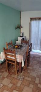 a dining room with a table with chairs and a tableablish at Cabaña Dos Pinos in Durazno