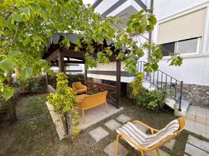 a patio with two chairs and a gazebo at Small Garden House in Draç