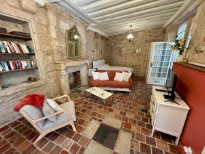 a living room with a bed and a fireplace at Studio Bardin in La Charité-sur-Loire
