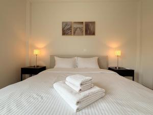 a bedroom with a white bed with towels on it at Nicosia Neoclassic Retreat in Nicosia