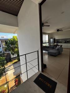 a living room with a couch and a view of a living room at Departamentos Nütuuk in Mérida