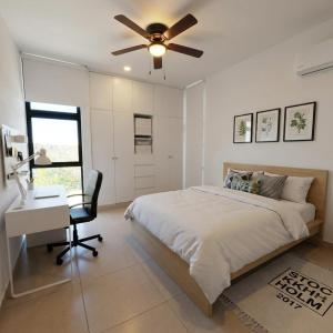 a bedroom with a bed and a desk and a ceiling fan at Departamentos Nütuuk in Mérida +7 photos