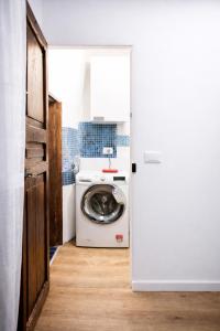 a washer and dryer in a kitchen with a door at Le Erbe Apartment tra Locali e vita Universitaria in Genoa +27 photos