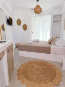 a bedroom with a bed and a rug on the floor at K&M studio in Naxos Chora