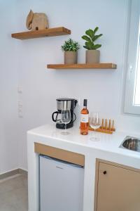 a kitchen counter with a coffee maker and wine glasses at K&M studio in Naxos Chora +11 photos