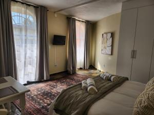 a bedroom with a large bed with pillows on it at The Studios on Smuts in Ermelo