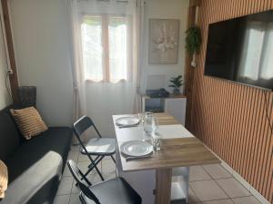 a small living room with a table and a couch at Le petit coin du pêcheur in Brouchaud +17 photos