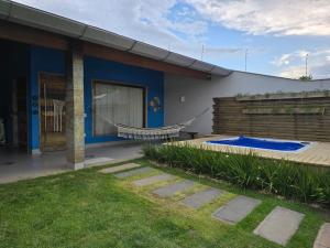 a house with a swimming pool in the backyard at Cabana da Cris in Anchieta