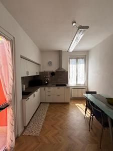 a kitchen with a table and a dining room at Il Vigneto in Le Grazie