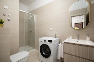 a bathroom with a washing machine and a sink at Apartments Dadic with parking & playground in Medulin +38 photos