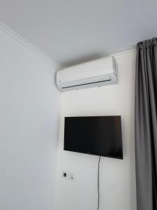 a flat screen tv on a wall in a room at Horizont Dobre Vode in Dobra Voda